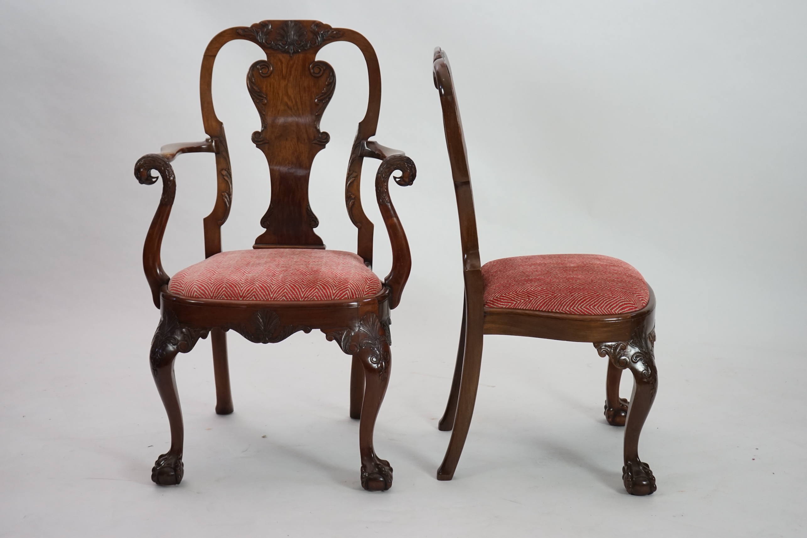 A set of twelve Queen Anne revival walnut dining chairs, including two carvers